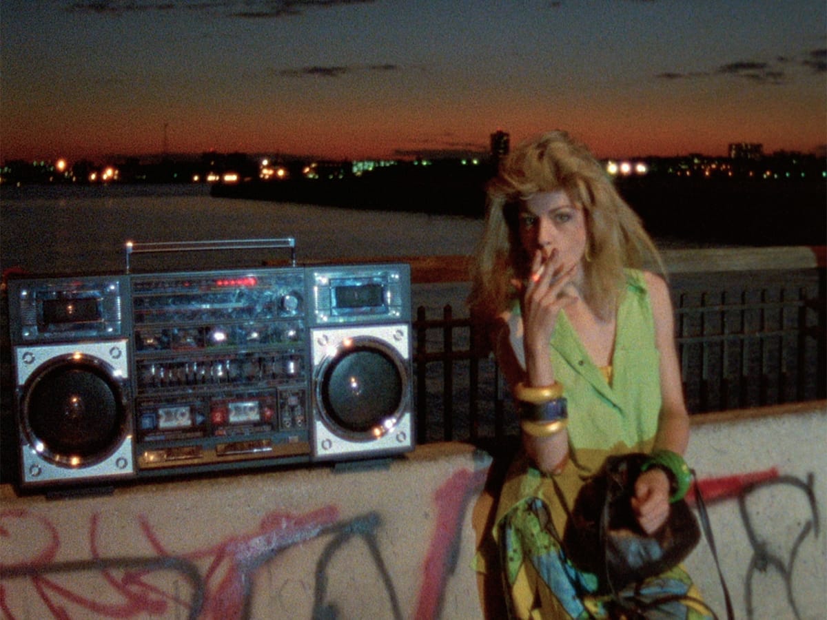 Paris is Burning | Still features a drag queen right next to a large boom box.