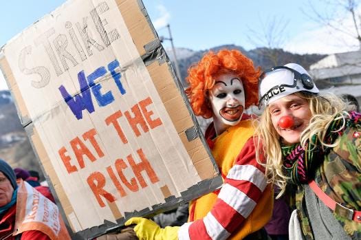 Participants of the climate protest march gather at the train station in Landquart, Switzerland, Sunday, Jan. 19, 2020. Around 500 activists came together to hike the 40 kilometers to Davos to protest against climate change and global warming next Tuesday. (Walter Bieri/Keystone via AP)
