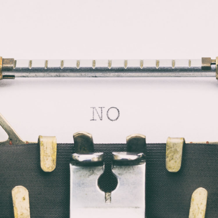 Typewriter with the word "no" representing being rejected by agents and publishers.