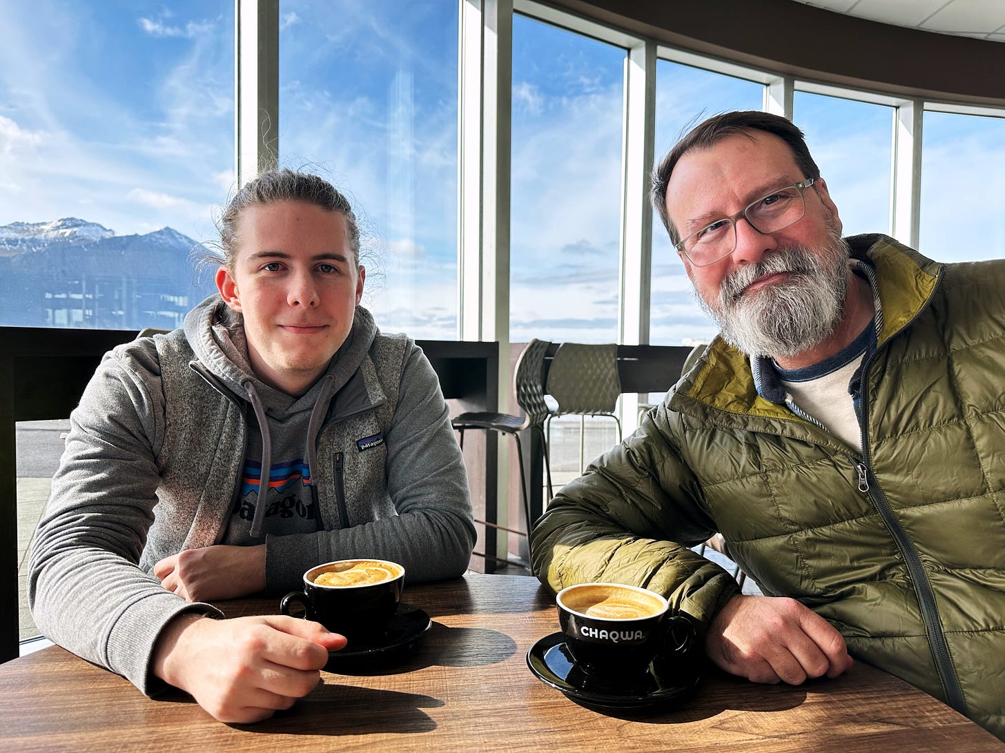 My husband, John and son, Ryan enjoying coffee in front of a curving wall of windows in a bakery in Borgarnes, Iceland.