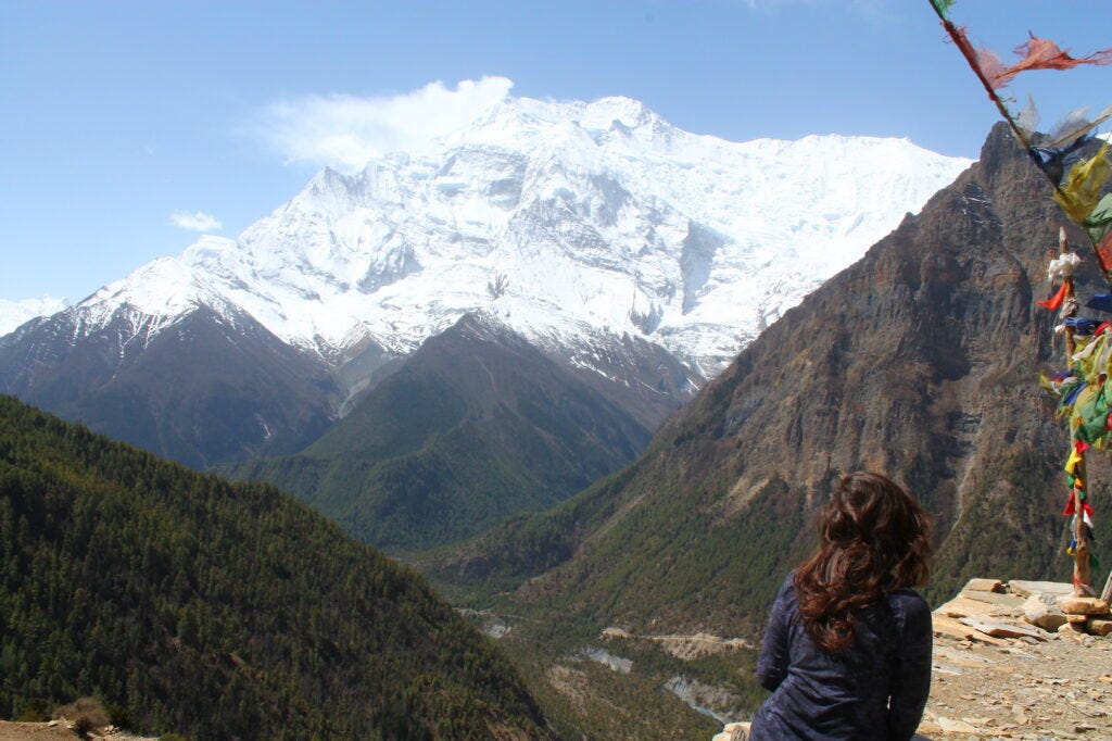 girl sitting by mountain view