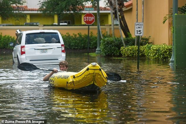 Residents asses the damage in the flooded streets of Fort Lauderdale after three days of heavy rainfall, April 13, 2023
