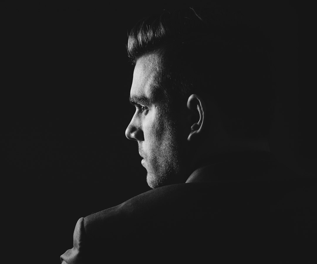 grayscale photo of man wearing blazer