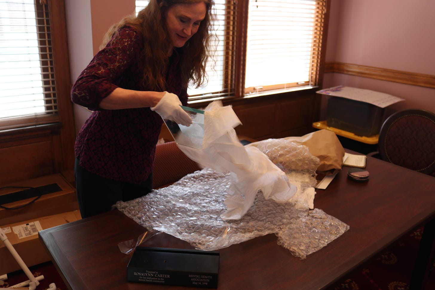 Michelle Gullion unwraps a new acquisition at the National First Ladies Library.