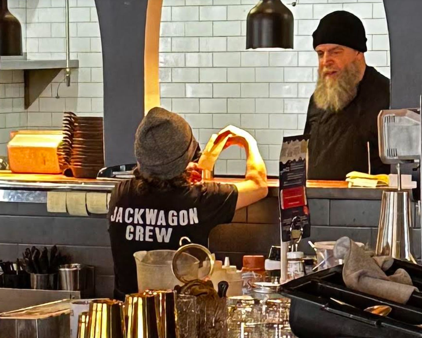 Kitchen worker wearing a t-shirt that says "Jackwagon Crew"