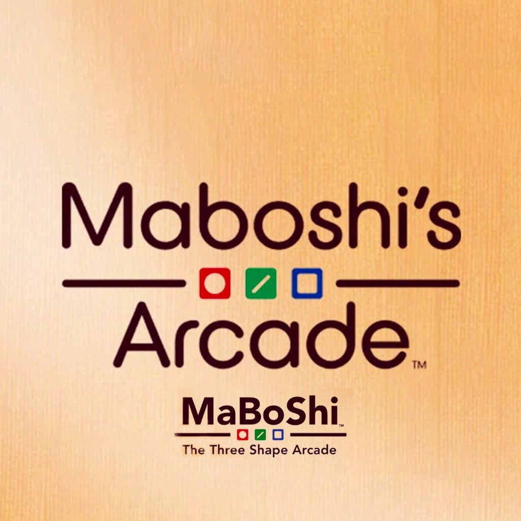 The image uses both titles of the game (Maboshi's Arcade as well as Maboshi: The Three Shape Arcade, set on the same wood-style background, with the three game "shapes" of circle, stick, and square in a row for both.