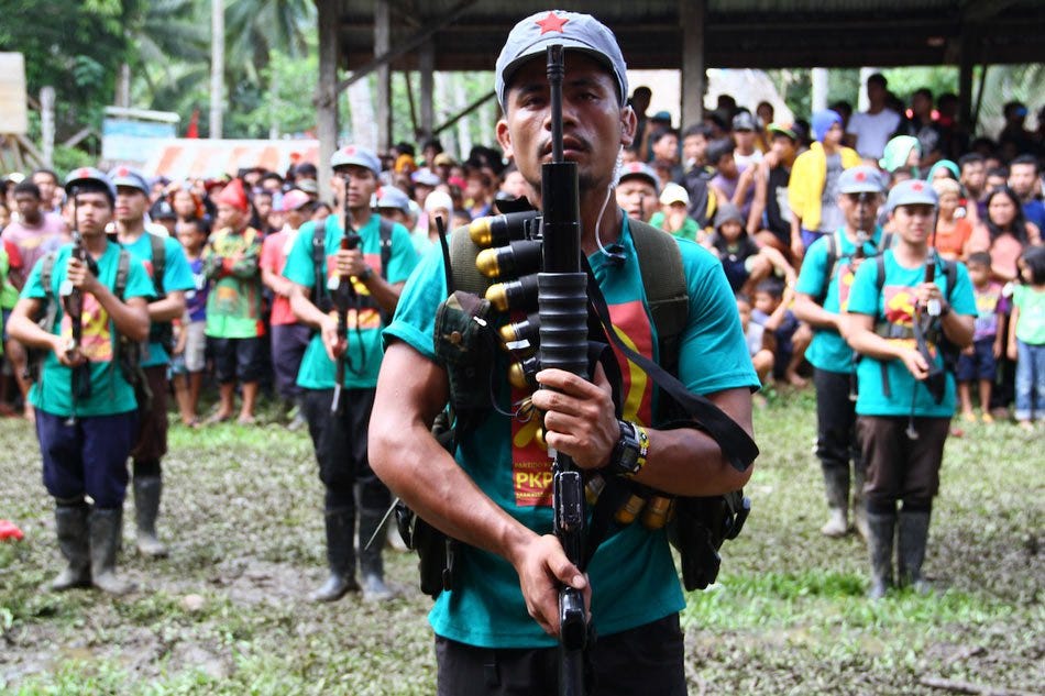 In this photo taken on December 26, 2014, members of the communists' armed wing, the New People's Army (NPA), stand in formation as they mark the 46th anniversary of its founding in a remote village on the southern island of Mindanao. Stringer, AFP