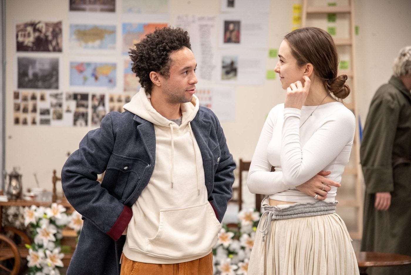 A photo showing two actors in rehearsals for Three Sisters, talking to each other