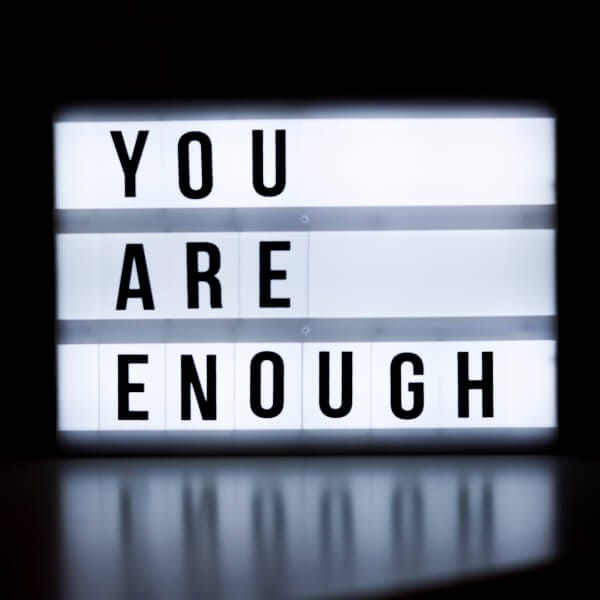 You are enough on a white sign with black background