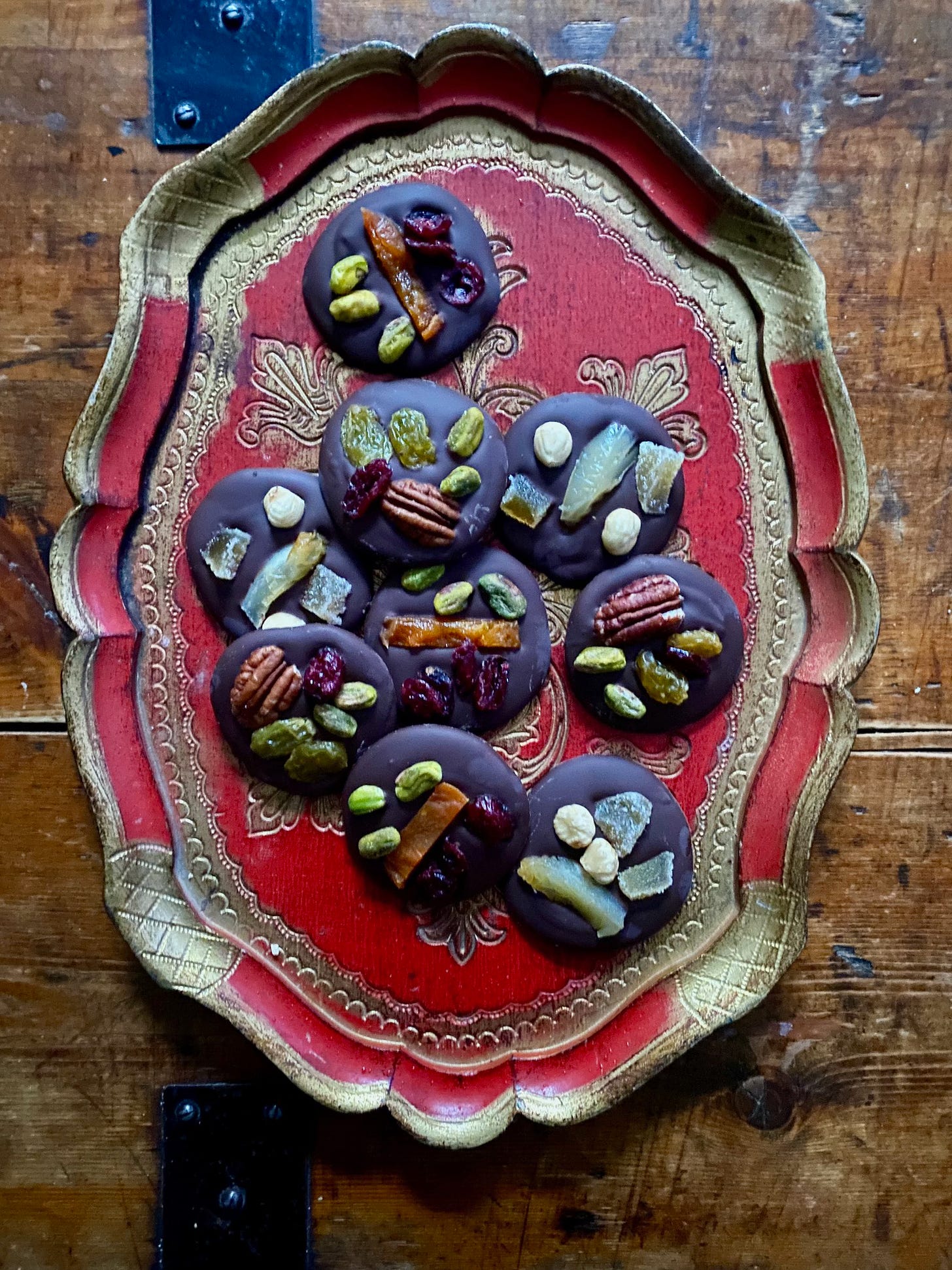 Chocolate discs topped with dried fruit and nuts