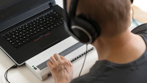 blind person using screen reader with braille output