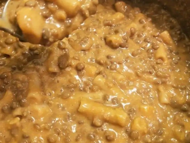 Not hamburger helping mac & cheese in the pot with a spoonful