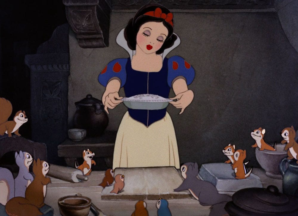 Snow White holds up a pie she's made admiringly - various forest creatures look on, also admiringly