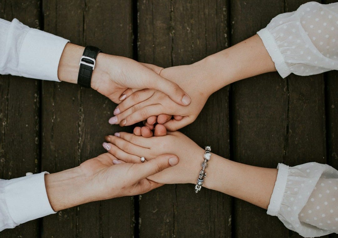flat lay photography of man and woman holding hands together flat lay photography of man and woman holding hands together