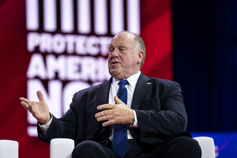 Tom Homan, wearing a suit, speaks while seated in an arm chair.