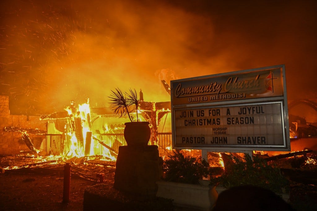 House engulfed in flames during a wildfire in Pacific Palisades, California, with residents fleeing the scene on January 8, 2025.