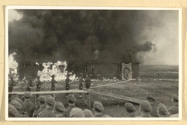 British forces ceremonially burning a barracks in Belsen, to which they have attached an image of Hitler, Enid Fordham’s Bergen-Belsen Photograph British forces ceremonially burning a barracks in Belsen, to which they have attached an image of Hitler, Enid Fordham’s Bergen-Belsen Photograph