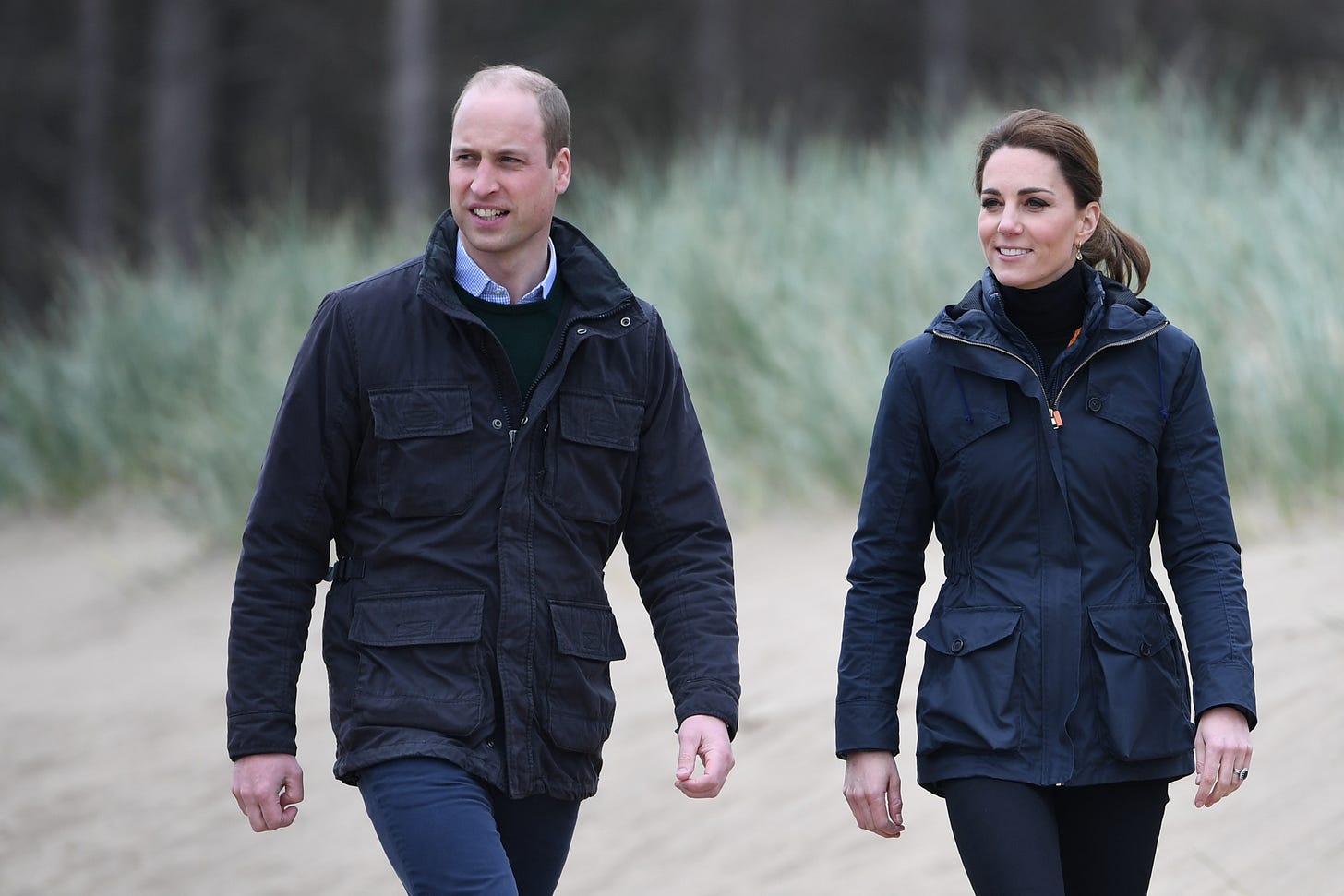 William and Kate walking on a beach in Anglesey