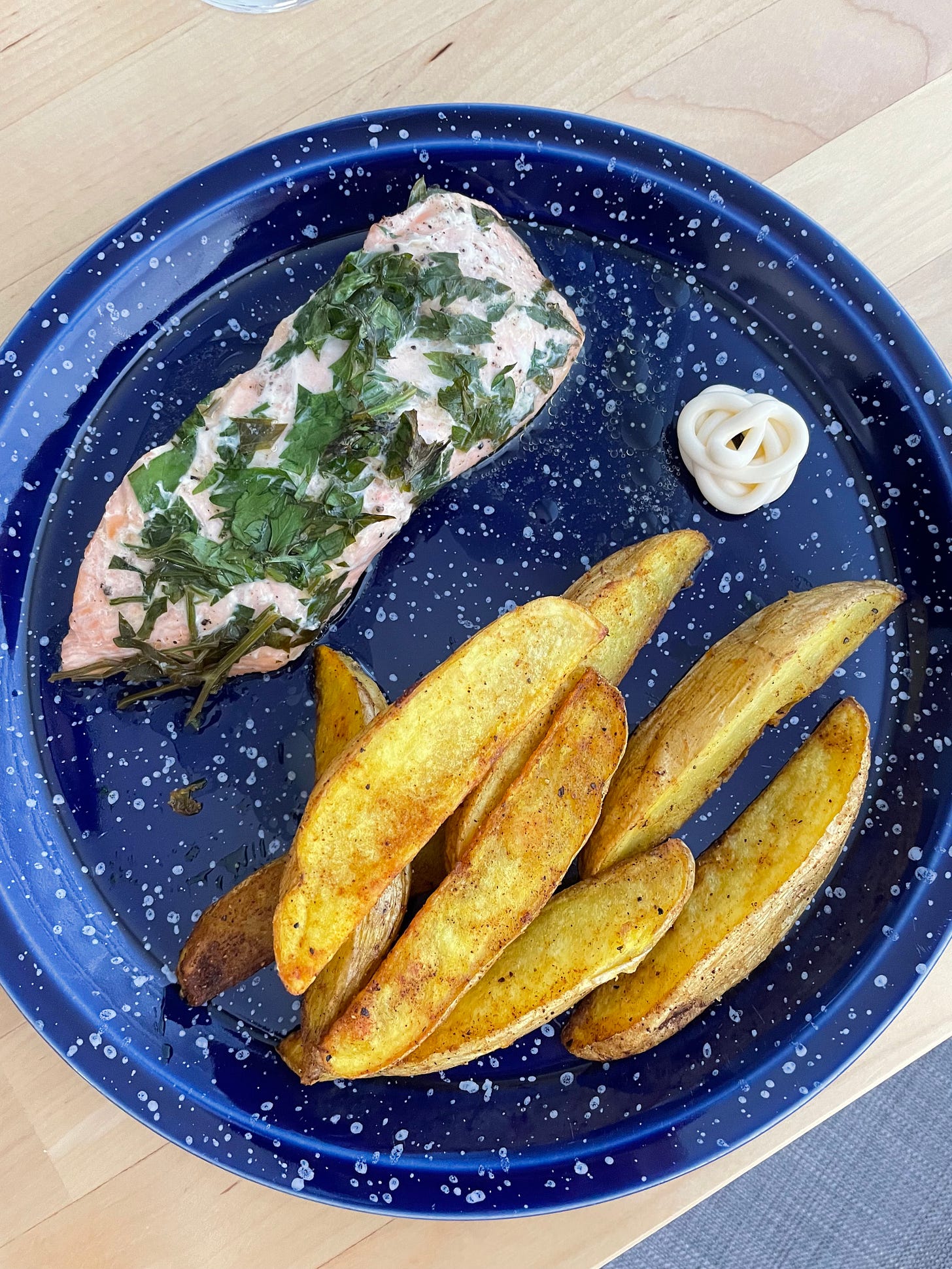 Baked salmon with butter, parsley, spiced wedges and a squirt of kewpie mayo.