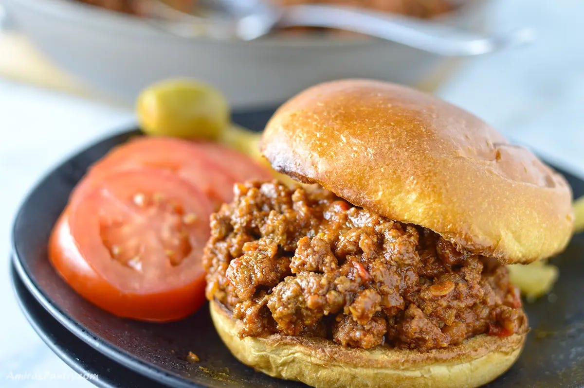 A close up look at a sandwich stuffed with sujuk.