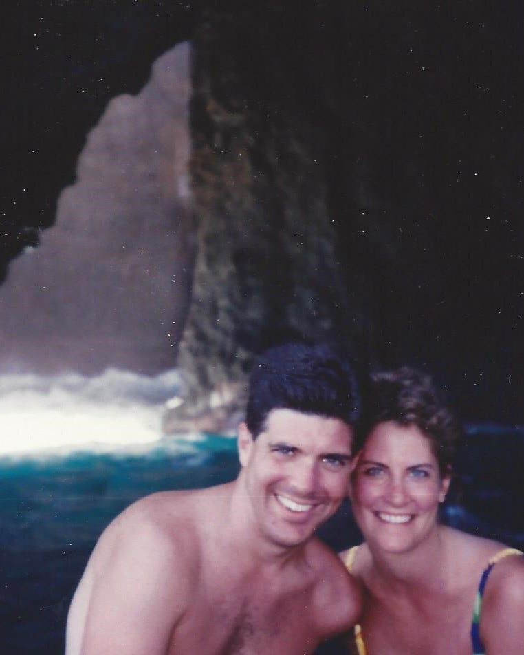 Young couple posed in front of breathtaking Hawaiian scenery
