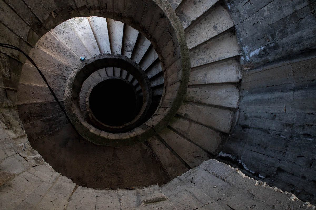 A spiral staircase in bare concrete.