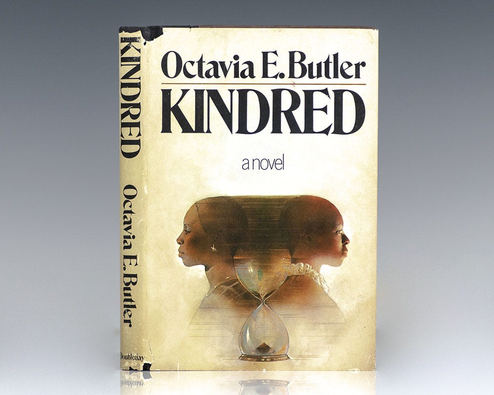 A book cover for Octavia E. Butler's "Kindred," showing two black women on either side of an hourglass