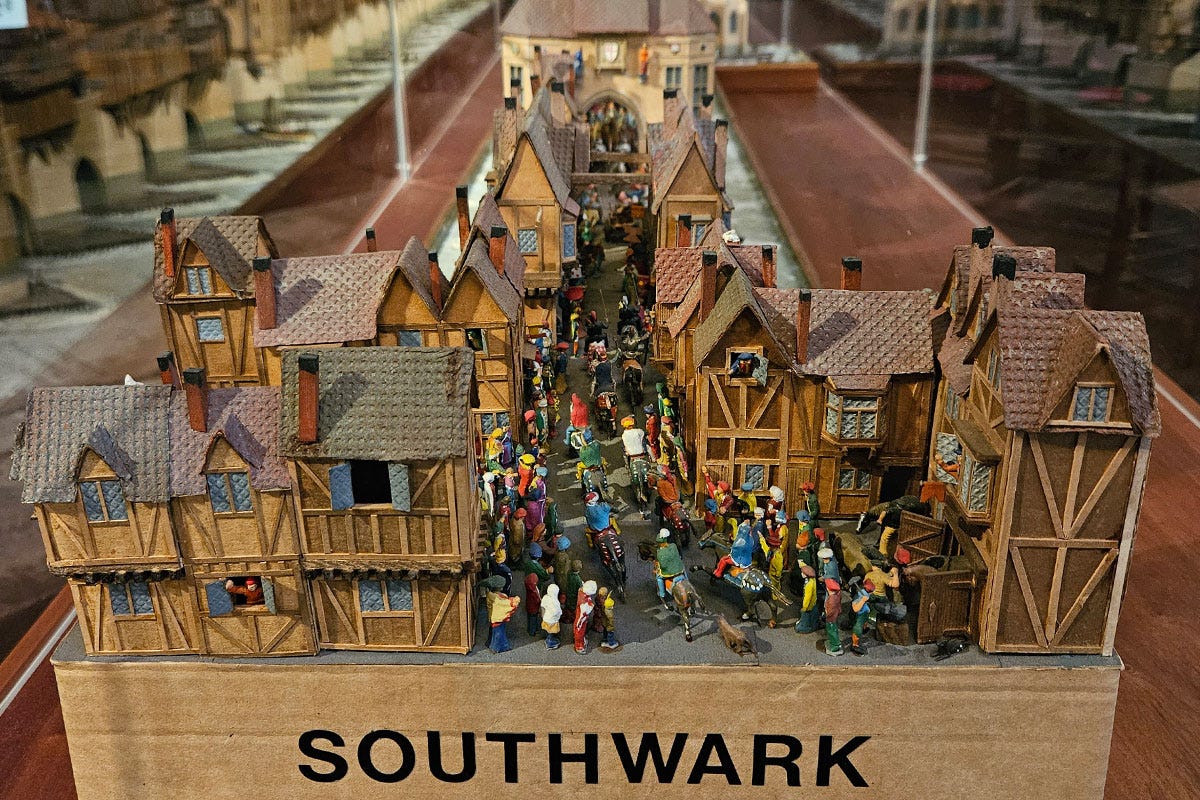 View from the end of a model of a medieval bridge with buildings and people on it. It's labelled Southwark.