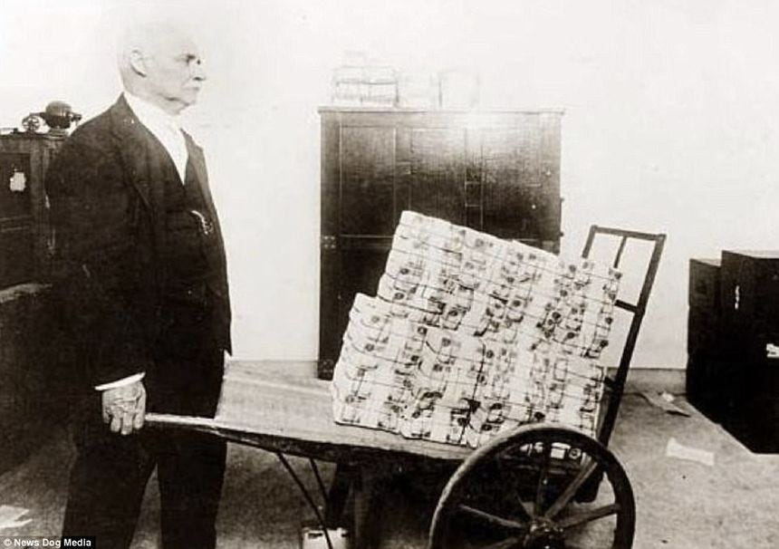 Pictured: A man carrying a wheelbarrow full of cash, which effectively became people's wallets due to hyperinflation in 1923