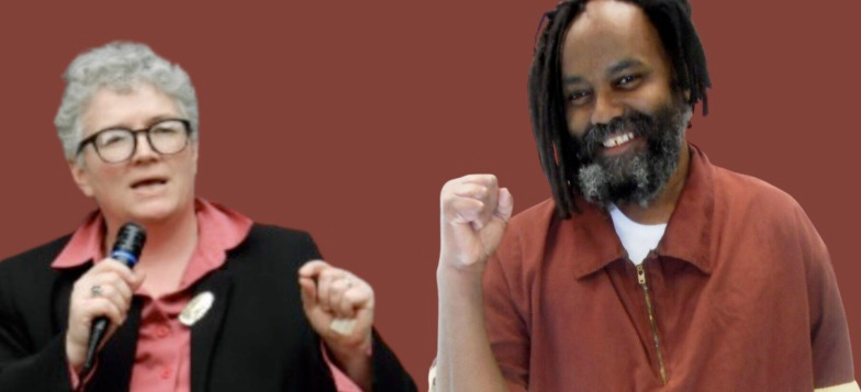 Noelle Hanrahan with a microphone next to Mumia Abu-Jamal smiling holding up a fist for solidarity