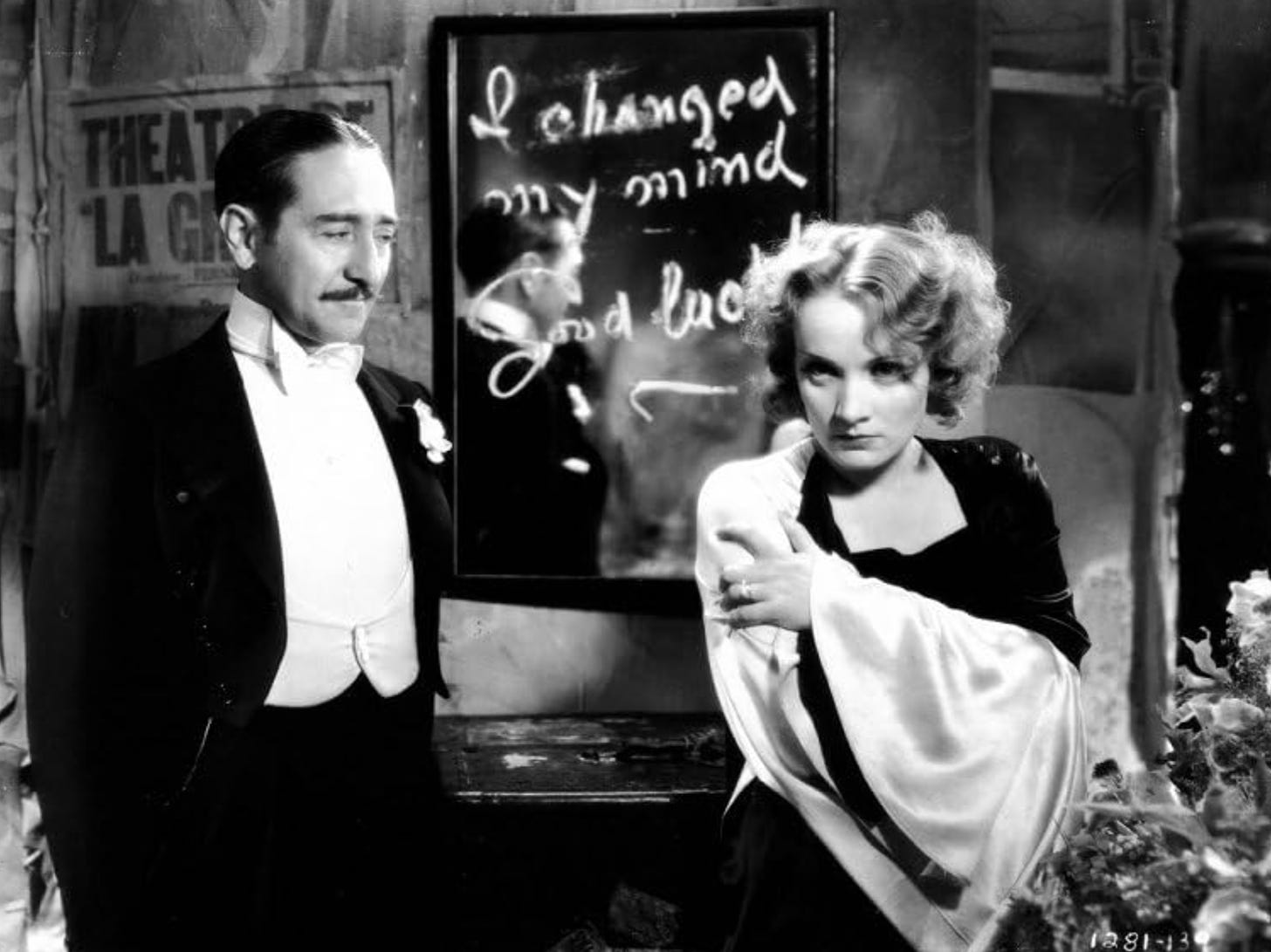 Marlene Dietrich stands in front of a mirror on which is written "I changed my mind. Good luck." in "Morocco" (1930)