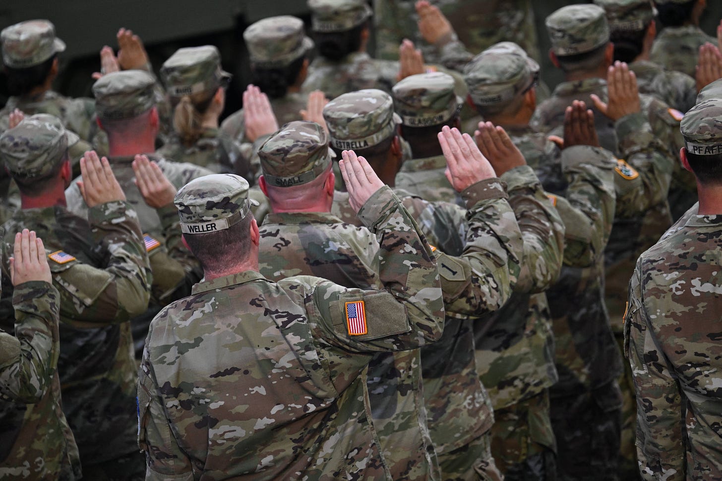 Soldiers raise the hands during the parade