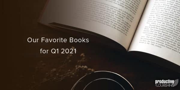 Book on a wooden desk. Text overlay: Our Favorite Books for Q1 2021