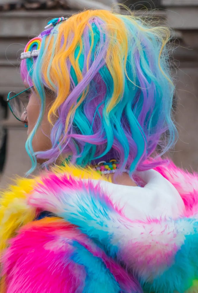 photo of person with multi colored hair and jacket in vibrant hues