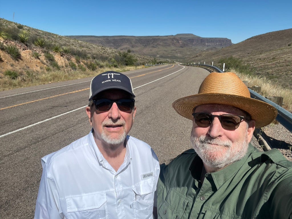 Two men taking a selfie on a road

Description automatically generated