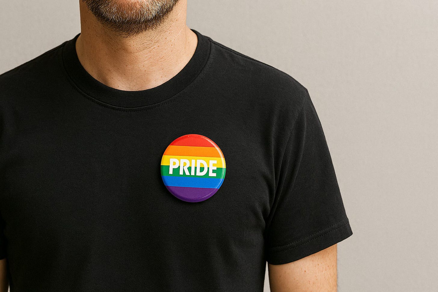 Man wearing a Pride button to show LGBTQ+ visibility and support.
