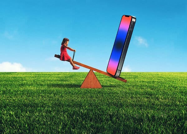 In this photo-illustration, a child sits on a seesaw set in a field of emerald green grass. On the other side of the seesaw is a giant smartphone.