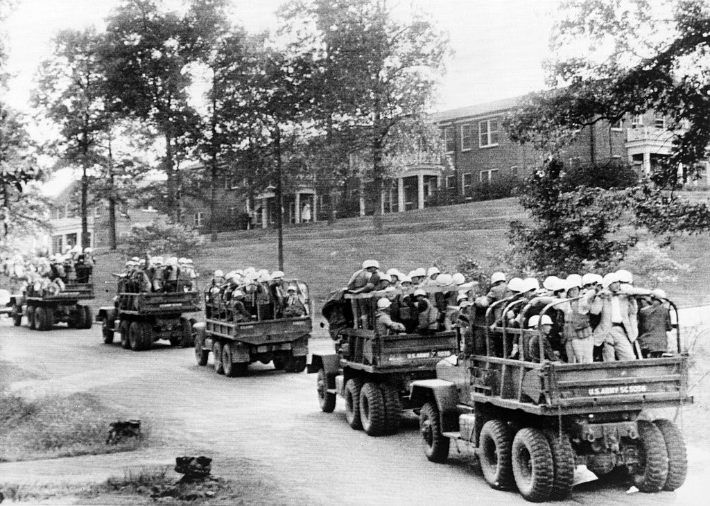 U.S. Army trucks loaded with steel-helmeted federal agents roll across the University of Mississippi campus