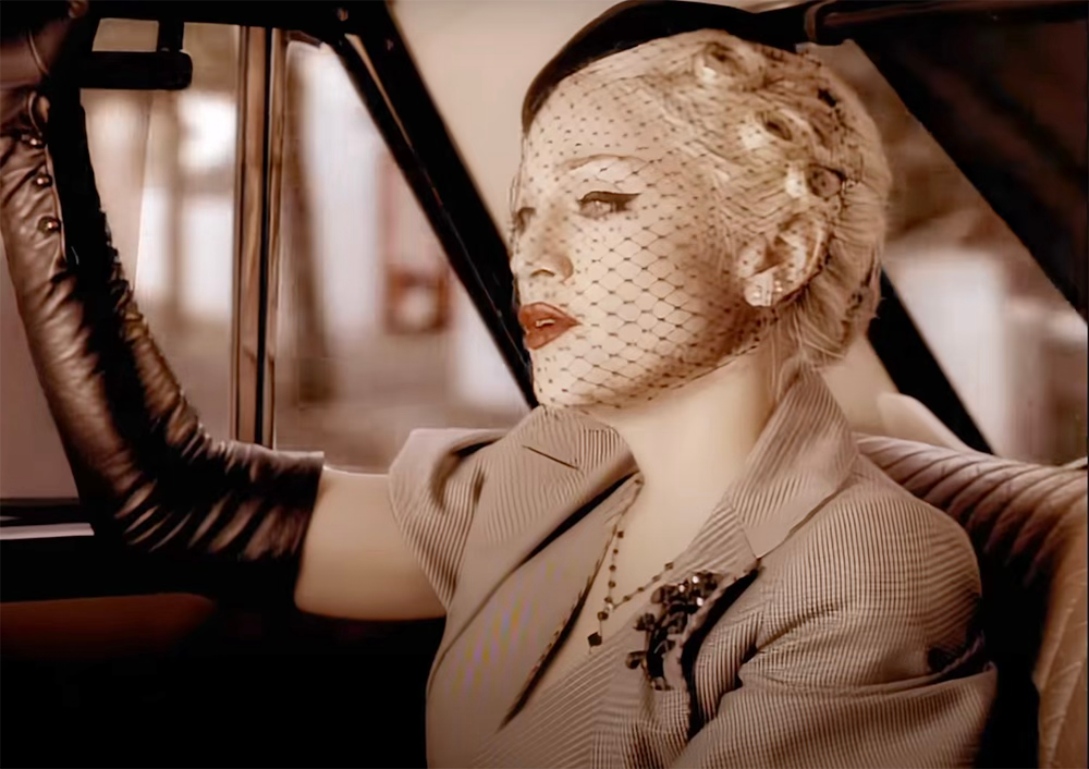 Madonna in the Take A Bow video sitting in a car