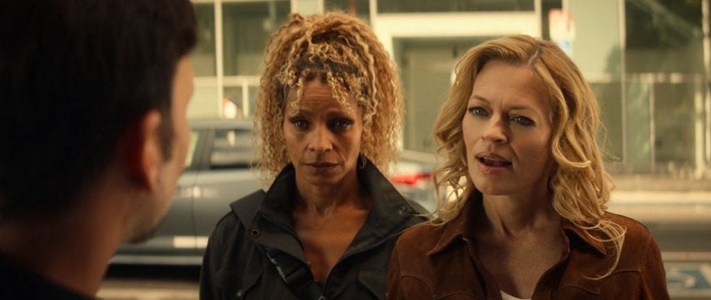 This image shows Raffi Musiker (played by Michelle Hurd, left) and Seven of Nine (played by Jeri Ryan, right) questioning the owner of a 2024 Los Angeles bar named Deacon's (played by Oscar Torre, back to camera) while searching for Agnes Jurati. This image shows Raffi Musiker (played by Michelle Hurd, left) and Seven of Nine (played by Jeri Ryan, right) questioning the owner of a 2024 Los Angeles bar named Deacon's (played by Oscar Torre, back to camera) while searching for Agnes Jurati.