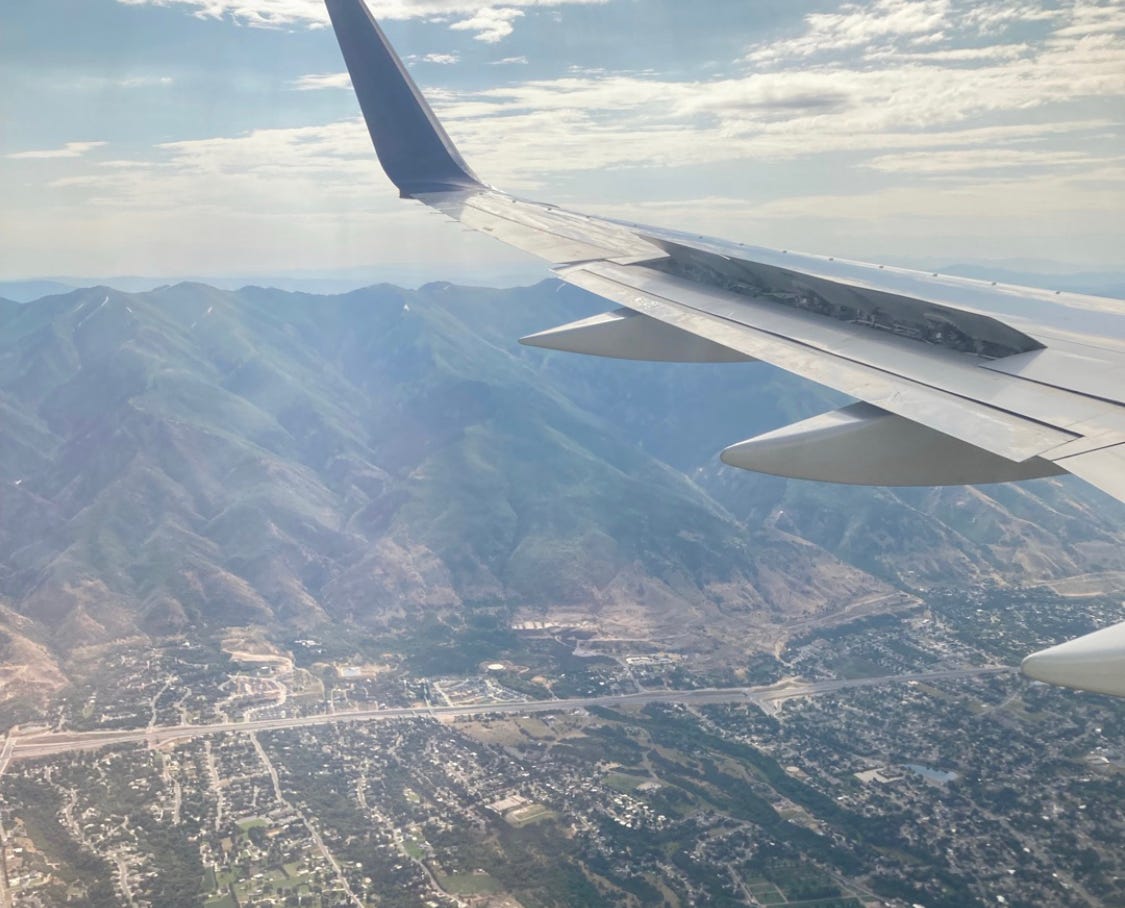 A view out a plane window on the valley below