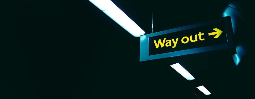 a black and yellow sign that says way out a black and yellow sign that says way out