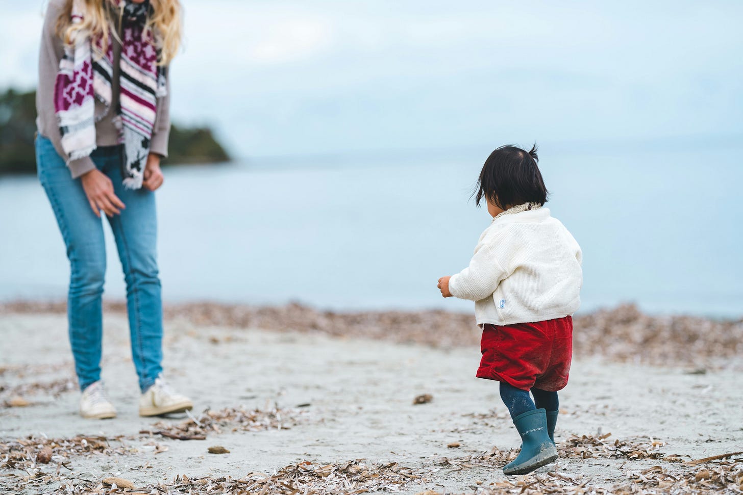 mother toddler playing on beach