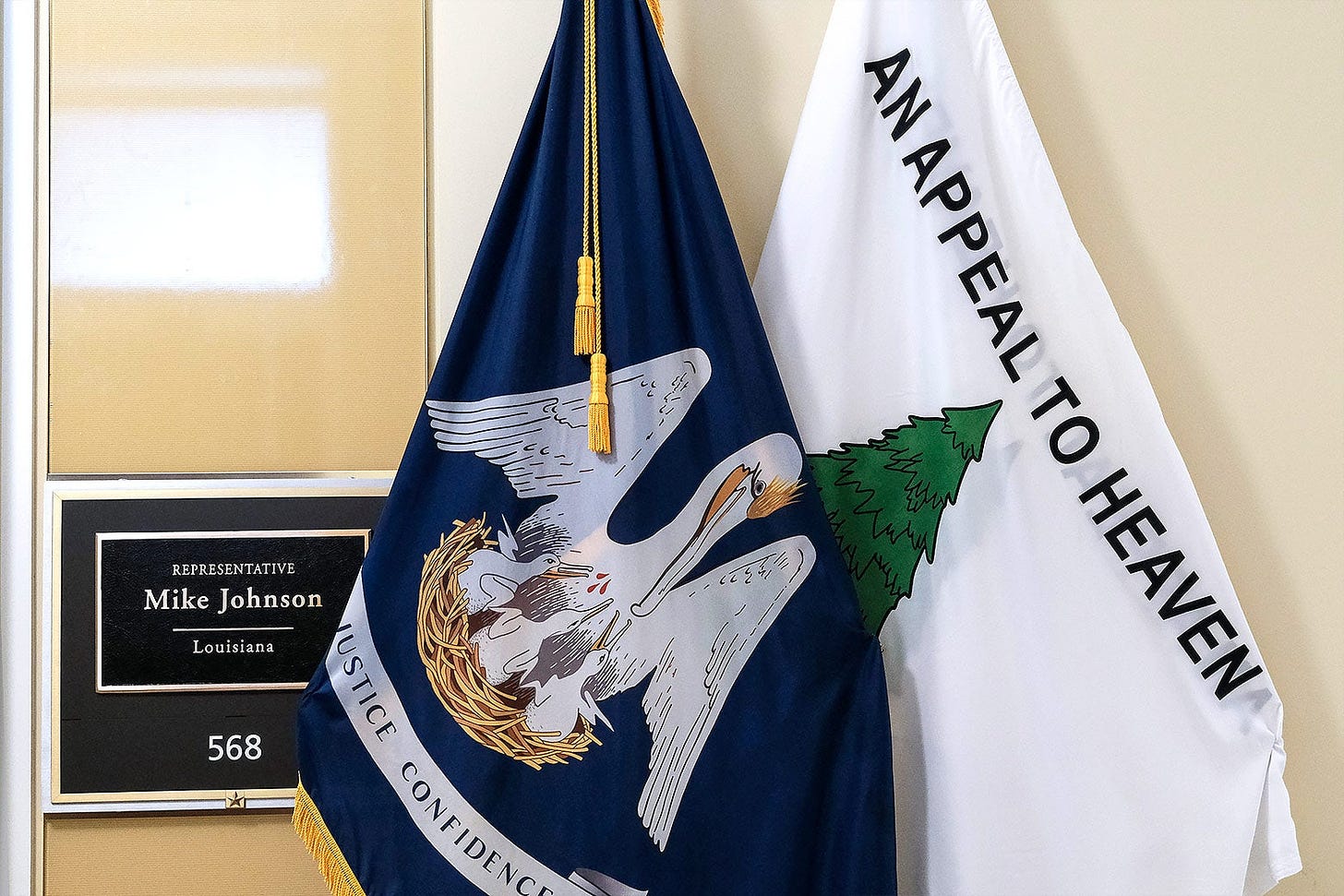 An Appeal to Heaven flag is seen outside Speaker of the House Mike Johnson's office next to the Louisiana state flag. 