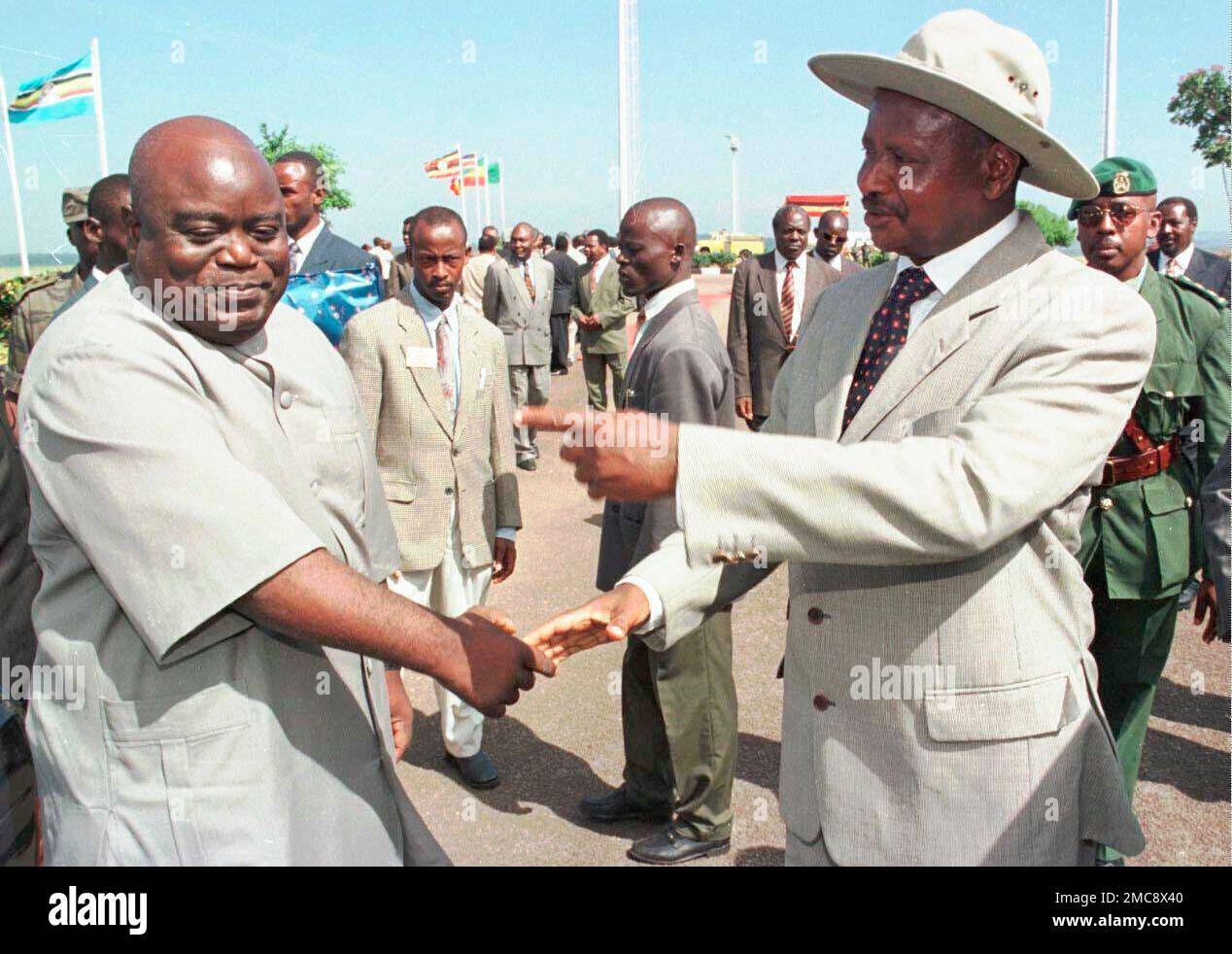 FILE - Congo's President Laurent Kabila, left, is greeted by Uganda's  President Yoweri Museveni upon his arrival at the airport in Entebbe, Uganda  on Jan. 23, 1998. The International Court of Justice