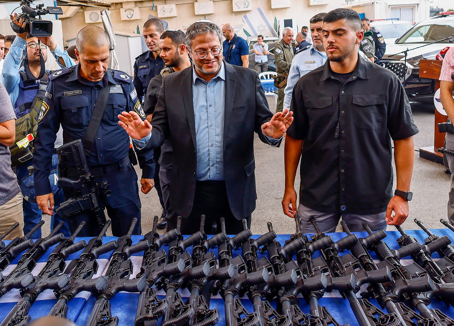 Israel’s National Security Minister Itamar Ben-Gvir handing out M5 automatic assault rifles
