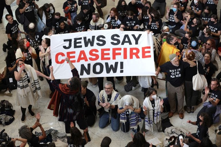 WASHINGTON, DC - OCTOBER 18: Protesters hold a demonstration in support of a cease fire in Gaza in the Cannon House Office Building on October 18, 2023 in Washington, DC. Members of the Jewish Voice for Peace and the IfNotNow movement staged a rally to call for a cease fire in the IsraelHamas war. Alex Wong/Getty Images/AFP (Photo by ALEX WONG / GETTY IMAGES NORTH AMERICA / Getty Images via AFP)