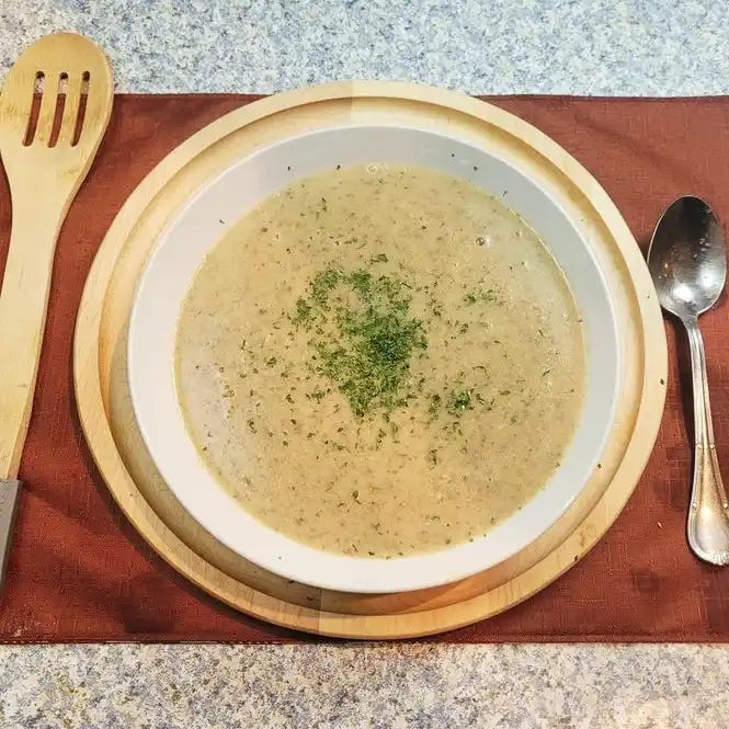 Featured image: Boil & Blend Creamy Mushroom Soup garnished in a white bowl and red table cloth