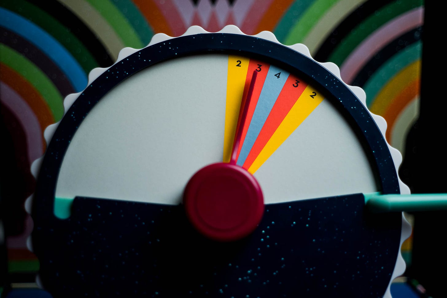 The dial from the game Wavelength on a table. The target is slightly to the right of center.