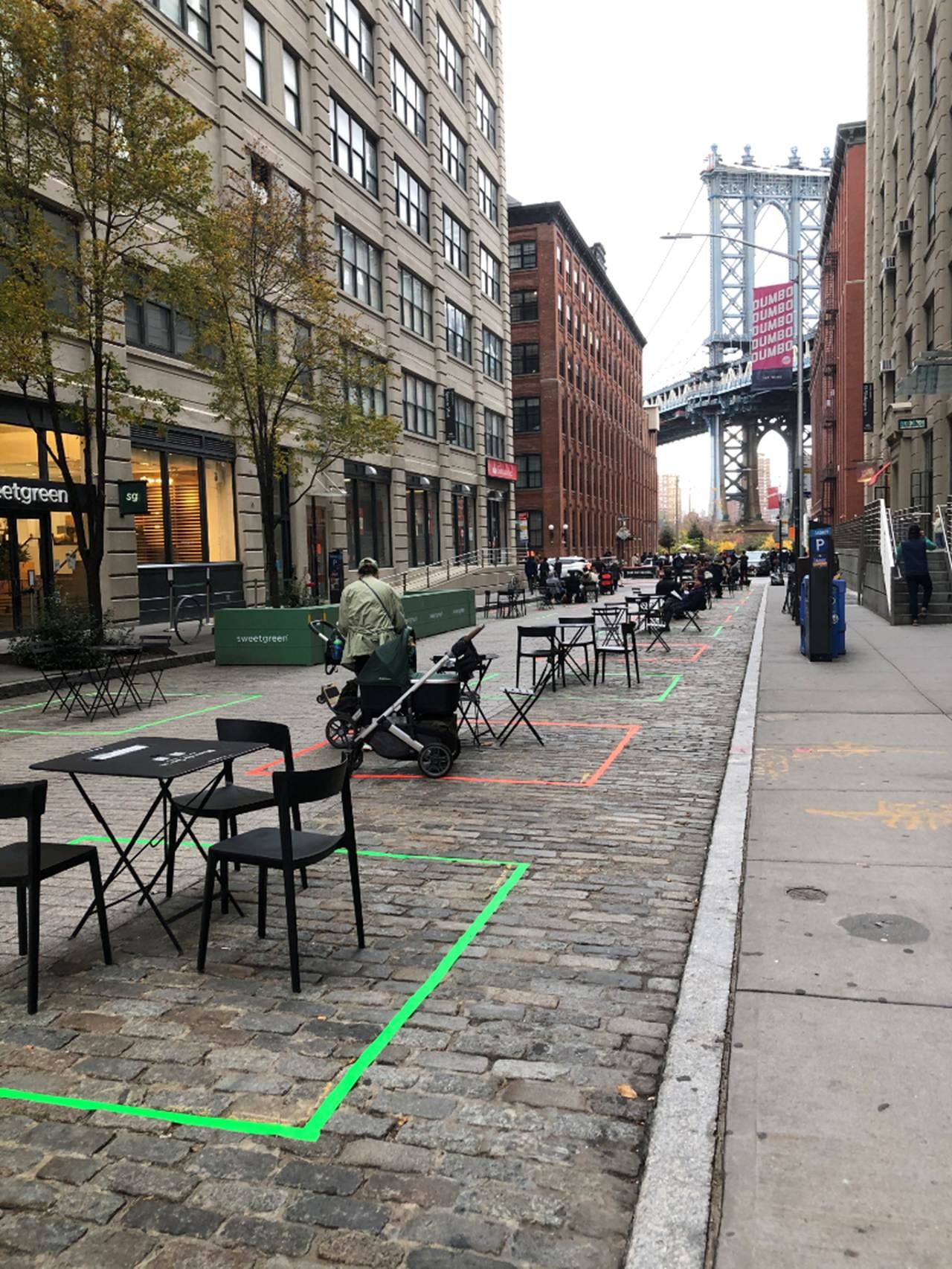 A sidewalk with chairs and tables

AI-generated content may be incorrect.